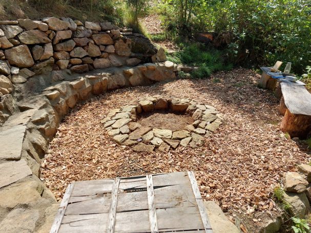 Feuerplatz aus Naturbruchsteinen Naturstein Feuerplatz mit Sitzflächen